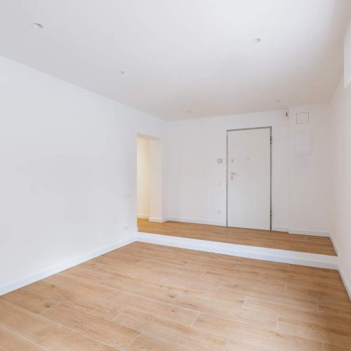 empty-clean-room-after-renovation-with-white-walls-window-and-wooden-floor