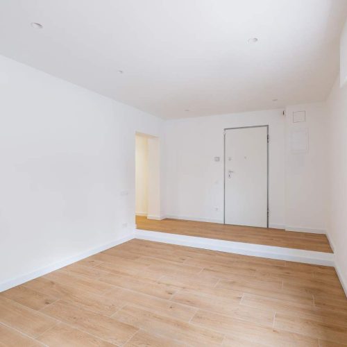 empty-clean-room-after-renovation-with-white-walls-window-and-wooden-floor.jpg