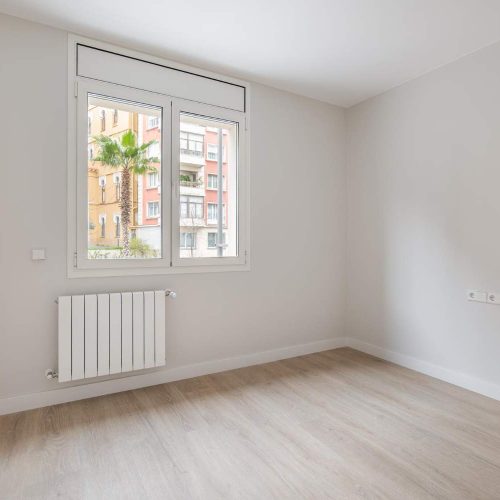 empty-white-room-with-heating-and-window-with-city-view-interior-of-modern-apartment