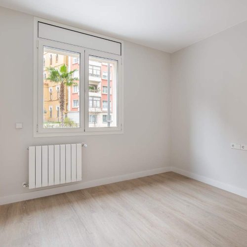 empty-white-room-with-heating-and-window-with-city-view-interior-of-modern-apartment.jpg