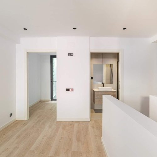 interior-of-empty-flat-with-doorways-leading-to-bedroom-and-bathroom-white-and-clean-room-in-refurbi